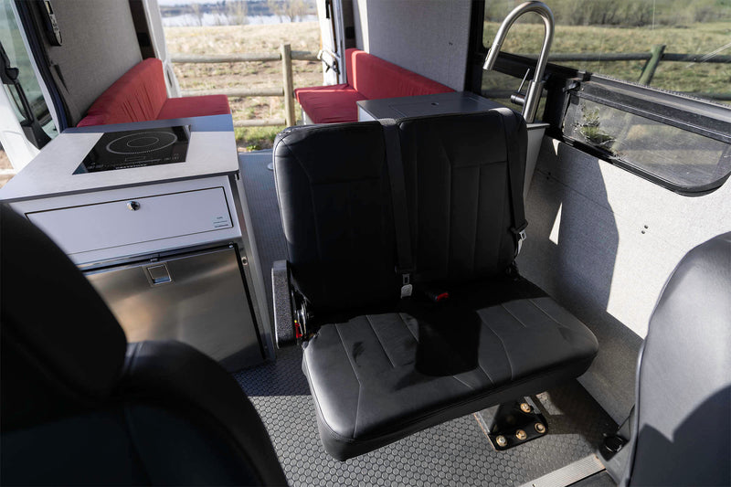  and a patterned floor lead to an open rear view of a field & lake.|This RV rental offers a detailed control panel: Xantrex inverter — photo 15