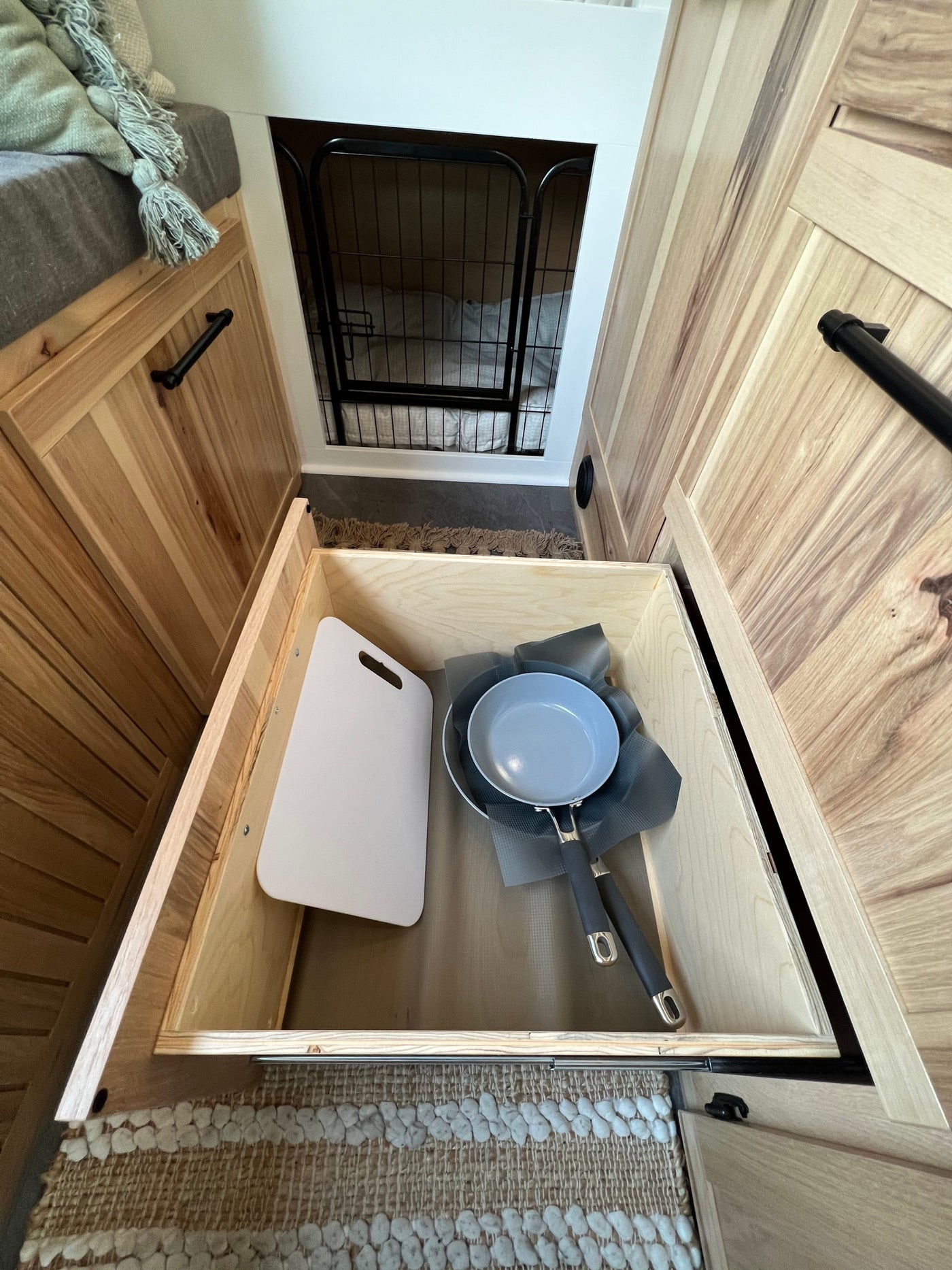  seating & pet nook.|Cozy RV rental interior featuring custom wood cabinetry — photo 6