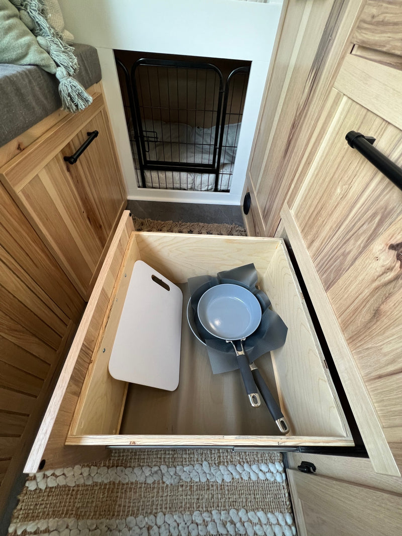  seating & pet nook.|Cozy RV rental interior featuring custom wood cabinetry — photo 6