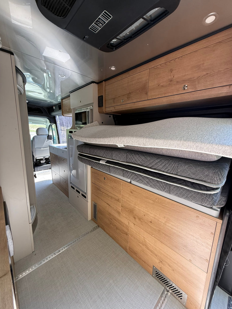  and light grey seats.|Step inside this modern RV rental featuring a kitchen with a sink
