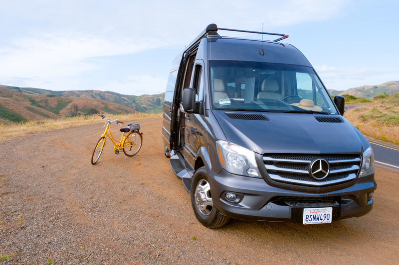 Grey Mercedes Sprinter rv rental van & yellow bike parked on a dirt pull-off. — photo 16