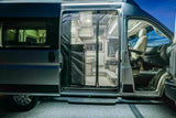 Modern RV rental camper van with open side door, showing the inviting interior living space and driver's cabin.