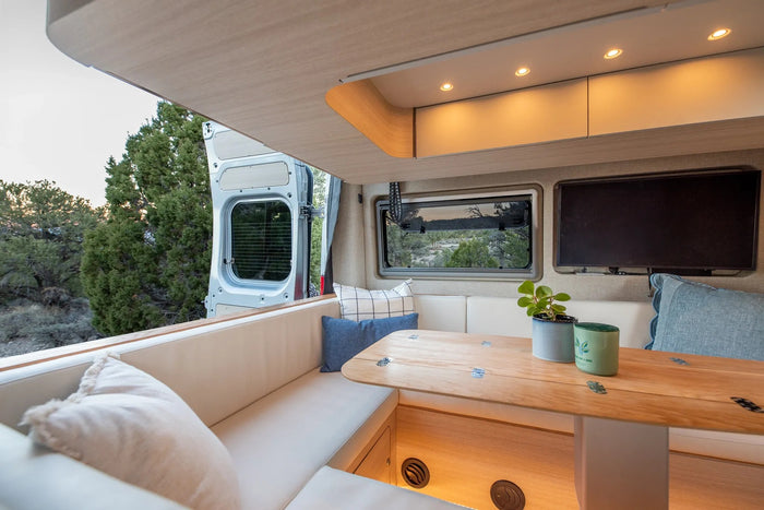 Spacious rv rental camper interior featuring a cozy dinette with scenic views, ambient lighting, and modern amenities.