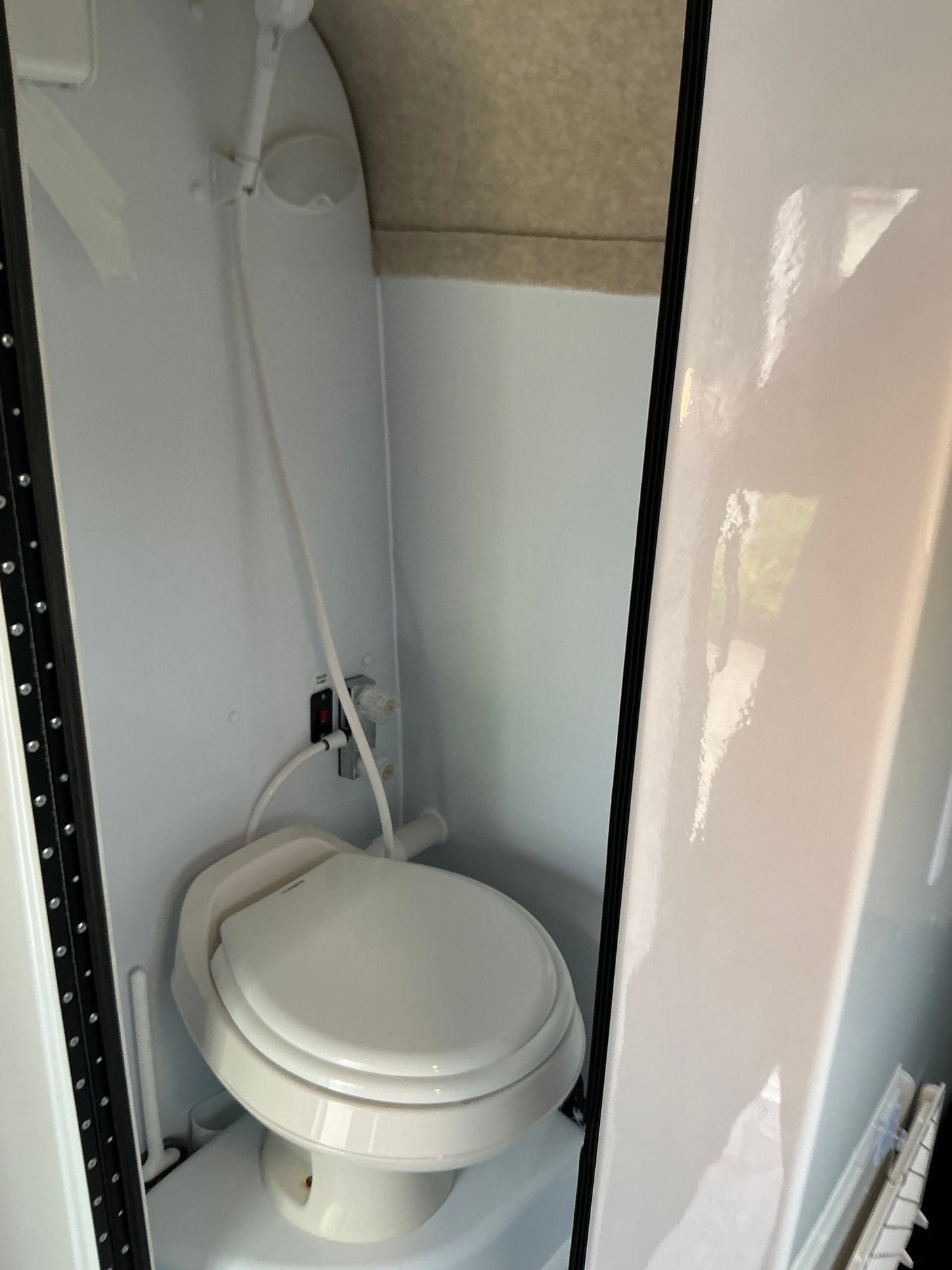 This RV rental's compact wet bath features a toilet and shower in one small, efficient space.