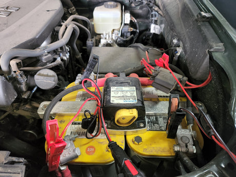 Dual battery setup in a vehicle engine bay, showing an Optima battery & charging relay. Ideal for RV rental trips.