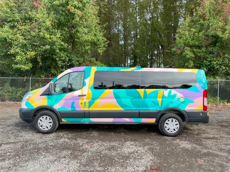 Colorful, abstract-painted passenger van, ideal for your next RV rental. Side view of unique custom vehicle.