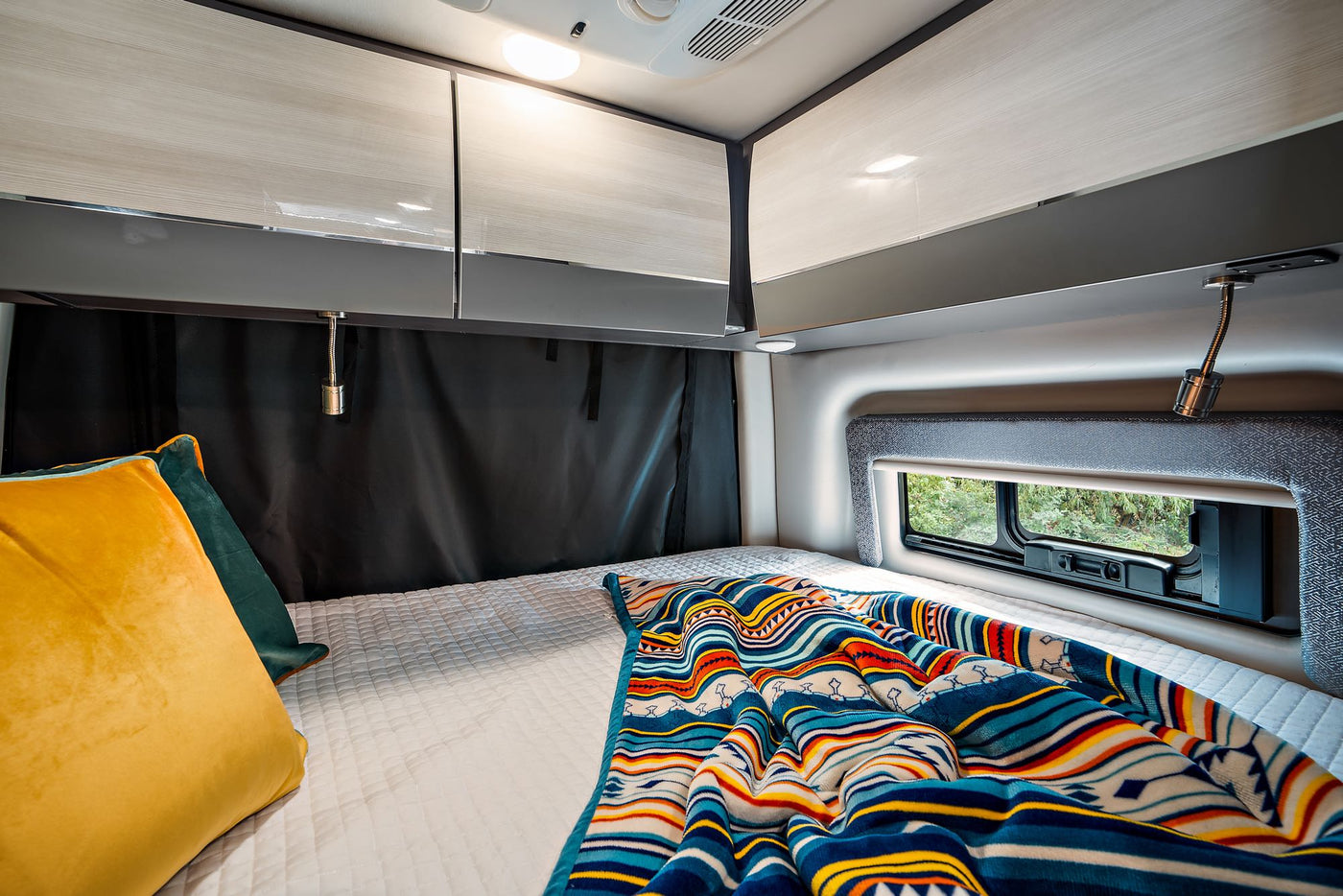  and extended awning for adventure travel. Perfect for van life.|This RV rental offers a compact kitchen with sink — photo 6