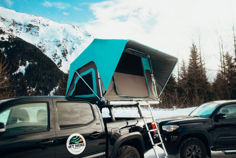 Explore with our RV rental alternative: a truck with a deployed teal rooftop tent, ready for mountain camping. — photo 7
