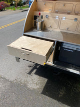 Teardrop camper's open outdoor kitchen with Dometic fridge & pull-out drawer. Great for your RV rental trips!