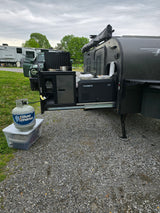 This RV rental features a pull-out outdoor kitchen with a Dometic cooler and a Blue Rhino propane tank, perfect for campsite cooking.