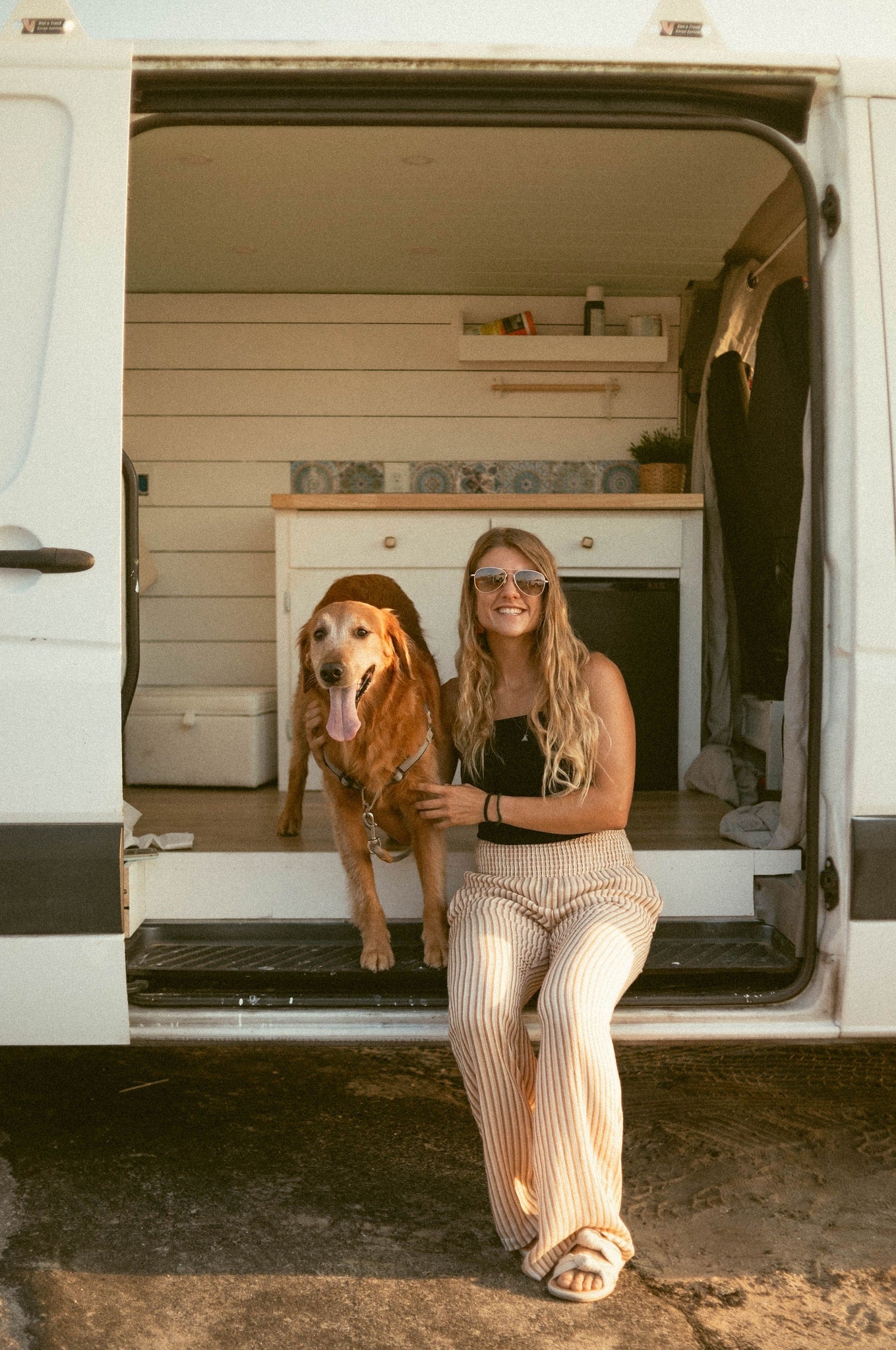 A smiling woman and her golden retriever in a cozy rv rental camper van. Perfect for pet-friendly travel. — photo 5