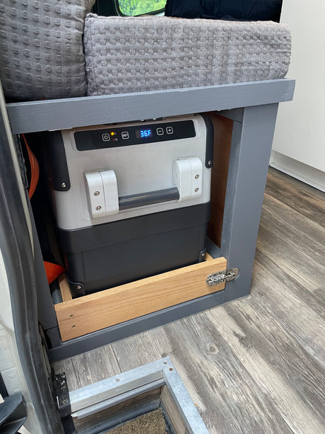 Portable refrigerator in custom cabinetry, set to 36F, ready for your next RV rental adventure.