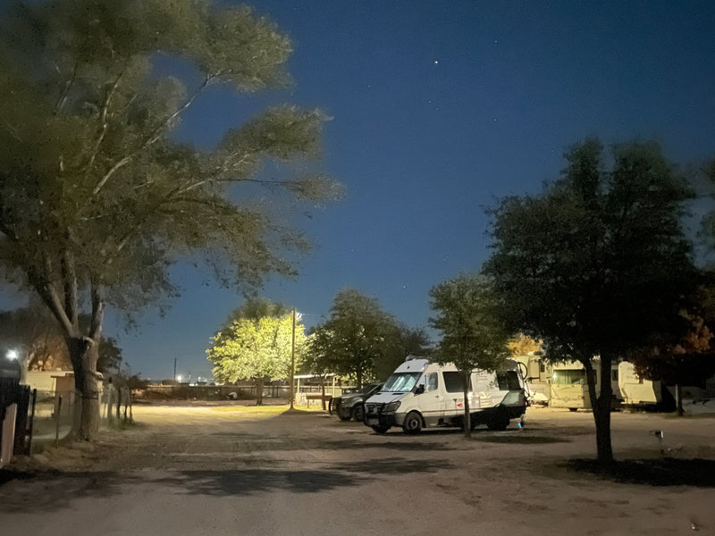  parked at night with headlights on. Tire tracks mark the cold — photo 4