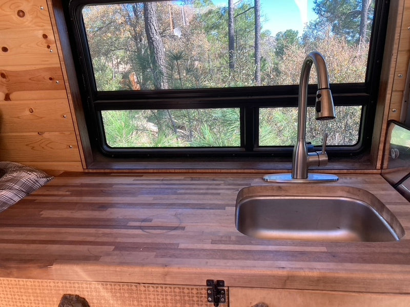  and roadrunner artwork.|Inside an RV rental: A camper van's kitchen area with a sink — photo 6
