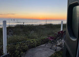 Spectacular beach sunrise from an RV rental. Ocean view with chairs, dune grass, and the sound of waves at dawn.