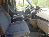 RV rental Ford van interior: front seats, dashboard, and sunny view. Ready for comfortable travel and adventure.