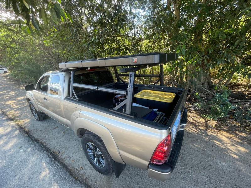 Tan Toyota Tacoma pickup with a bed rack & rooftop tent, full of camping gear. A perfect RV rental for rugged adventures. — photo 12