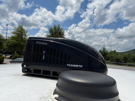  and a dining area with bench seating and TV.|RV rental Dometic climate control panel: Knobs for fan (blue/black arcs) and temp (red/blue arcs
