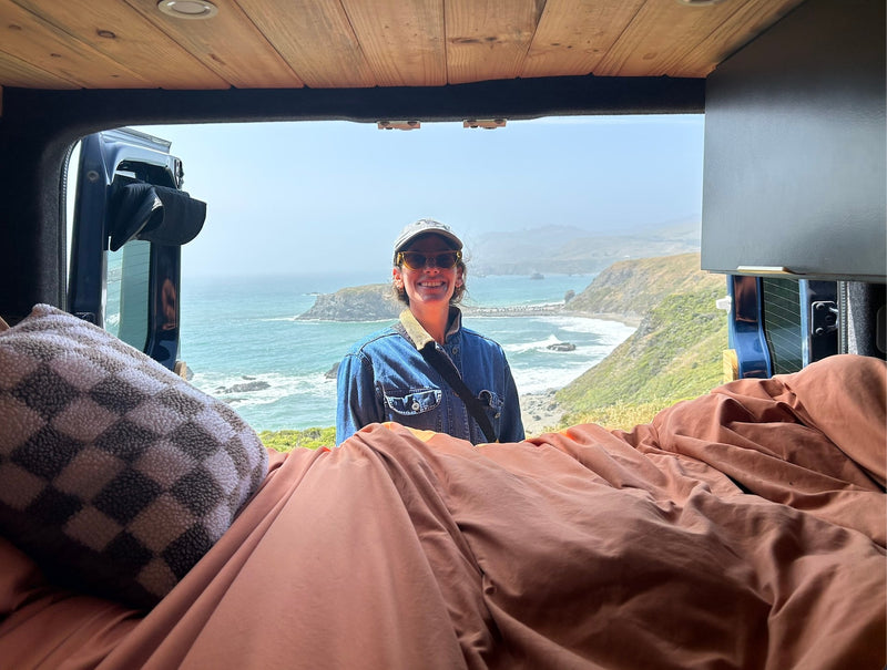  and people strolling.|Cozy custom RV rental interior with wooden bed area — photo 11