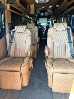  and sleek cabinetry towards the rear.|Step inside this luxury RV rental: plush leather seating — photo 6