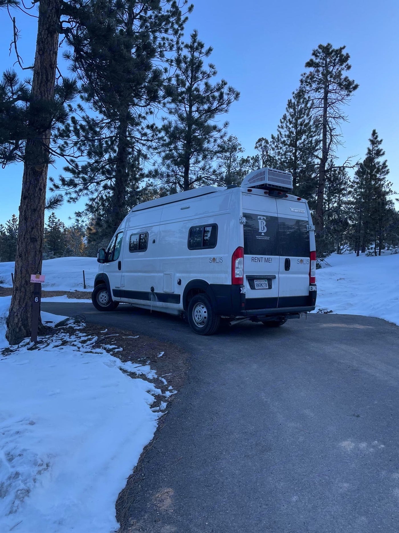  and a view outside.|An RV rental camper van with pop-top is parked at desert site 16 — photo 19