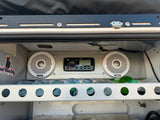 Custom RV rental setup features a Fusion stereo, speakers, and water bottles in a lit storage area. Good vibes!