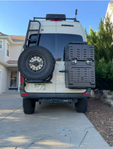 Custom Sprinter camper van, ideal for rv rental, showing rear-mounted OWL gear, spare tire & ladder.