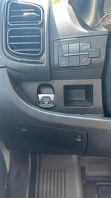 RV rental dashboard: air vents, light controls, electronic parking brake button ("PULL ON P"), and cubby on the driver's side.