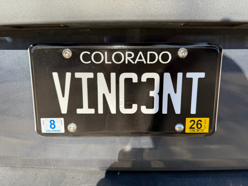 Colorado RV rental license plate "VINC3NT" with an August 2026 expiration sticker, seen on a vehicle's rear. — photo 1
