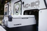 A Dometic portable fridge in a No Boundaries **rv rental** compartment. Essential outdoor gear for camping adventures!