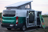 White & green Ford Transit rv rental camper van, pop-top raised, with open side doors & surfboard.