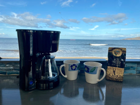 Morning coffee ritual in an RV rental, overlooking the ocean: Black+Decker brewer, mugs, and Royal Kona coffee.