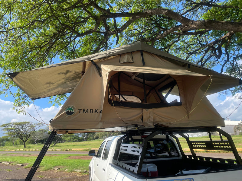 Explore with this RV rental: a white pickup truck equipped with a TMBK 4 rooftop tent for camping under large trees. — photo 8