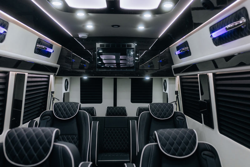 Experience luxury RV rental travel! Spacious custom van interior with quilted leather seating, microwave, and LED lighting. — photo 20