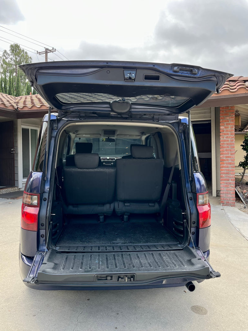 reveals a versatile interior for RV rental adventures. Perfect utility vehicle.|Honda Element interior showing reconfigured seats for a spacious cargo/sleeping area — photo 6