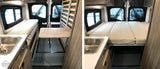 Versatile RV rental: Interior converts from dining table & bench to a full bed for comfortable sleep.