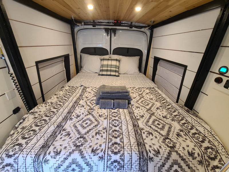  and cozy upholstered benches.|RV rental dining space: a wooden table holds colorful dishware — photo 26