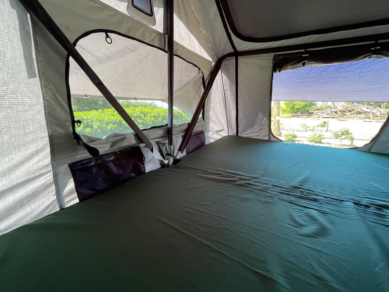 Inside an RV rental's rooftop tent, featuring a comfortable bed, mesh windows, and outdoor views. — photo 12