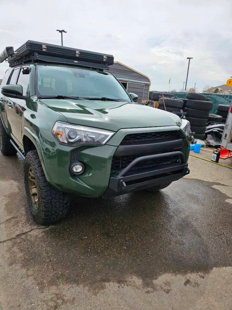 featuring a deployed rooftop tent in a scenic forest.|View from open door of an SUV's rear cabin. Black leather seats offer comfort for your next rv rental road trip.|Spacious SUV cargo area — photo 4