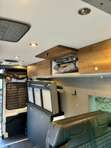 Versatile RV rental interior featuring convertible seating, overhead storage, and thermal window covers.