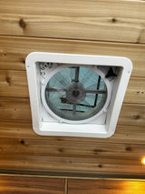 RV rental with a ceiling-mounted ventilation fan. Features include wood paneling & controls for airflow, temp, & open/close.