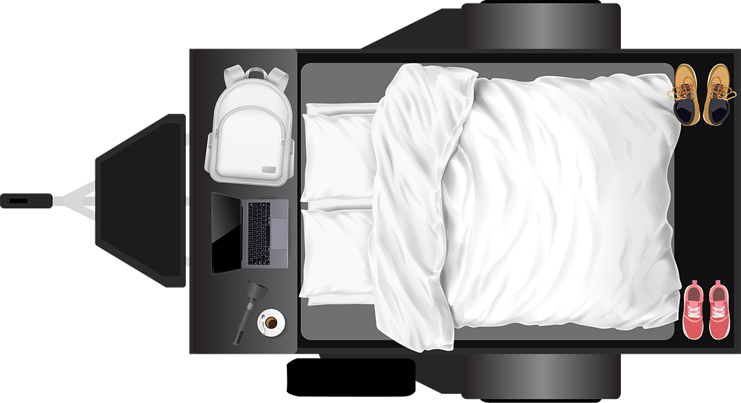 Overhead view of an RV rental's organized interior: bed with white linens, side table with laptop, backpack, coffee, and shoes.