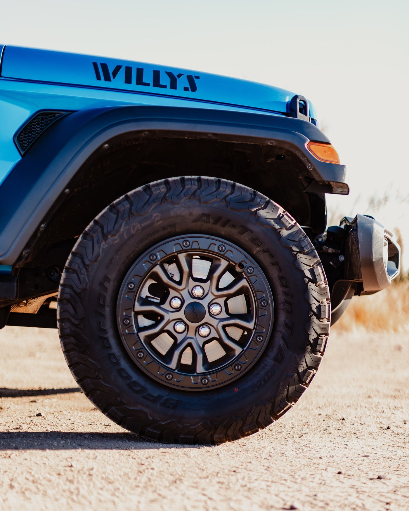 Blue Jeep Willys, with rugged BFGoodrich All-Terrain tires, poised for adventure. Ideal for an rv rental outdoor escape! — photo 14