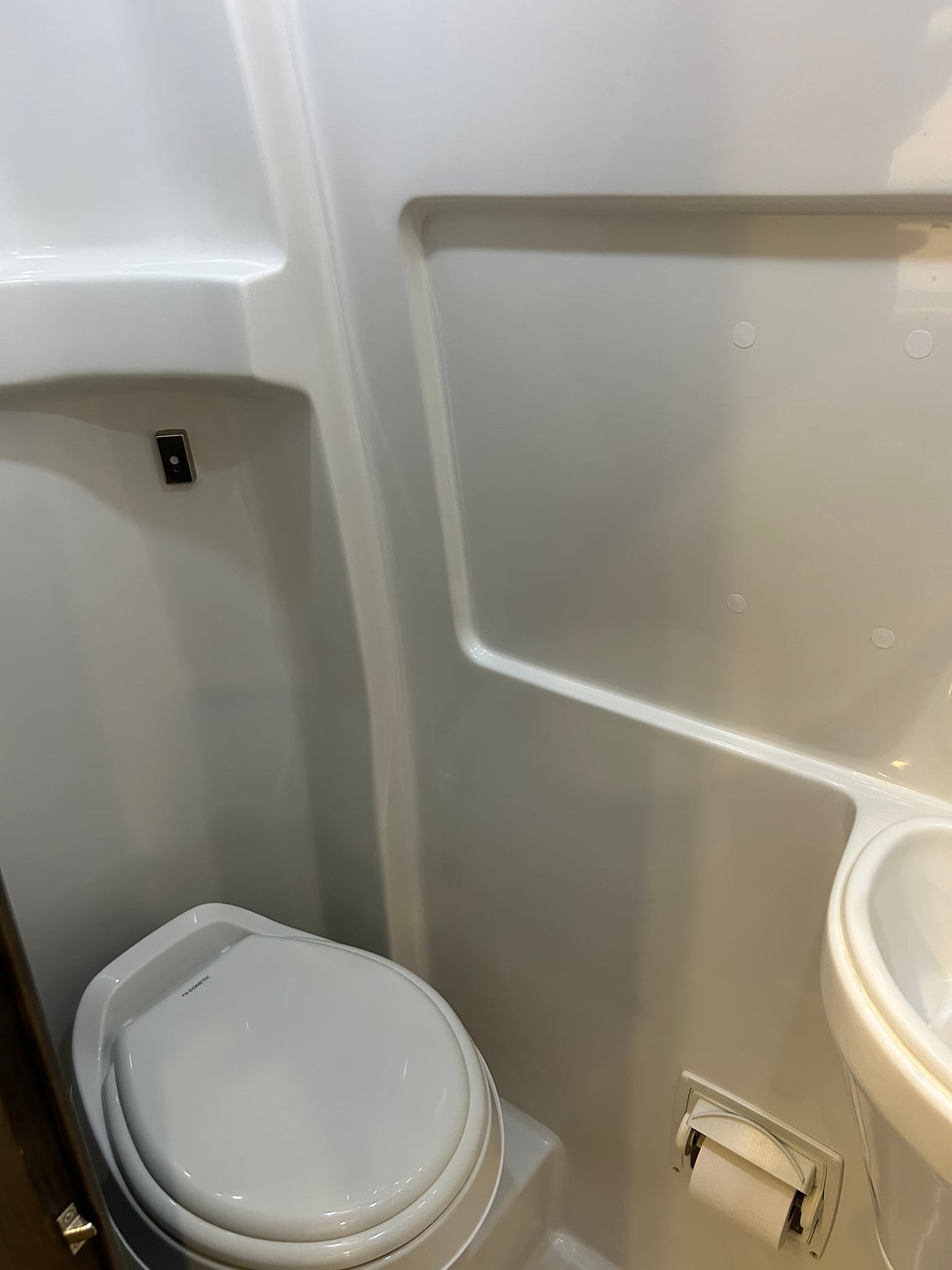  plus comfy leather seating.|Modern RV rental interior features a compact kitchen with stove — photo 12