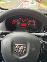 Driver's view in a Ram ProMaster, showing the illuminated dashboard, steering wheel, and road ahead. Explore rv rental options.