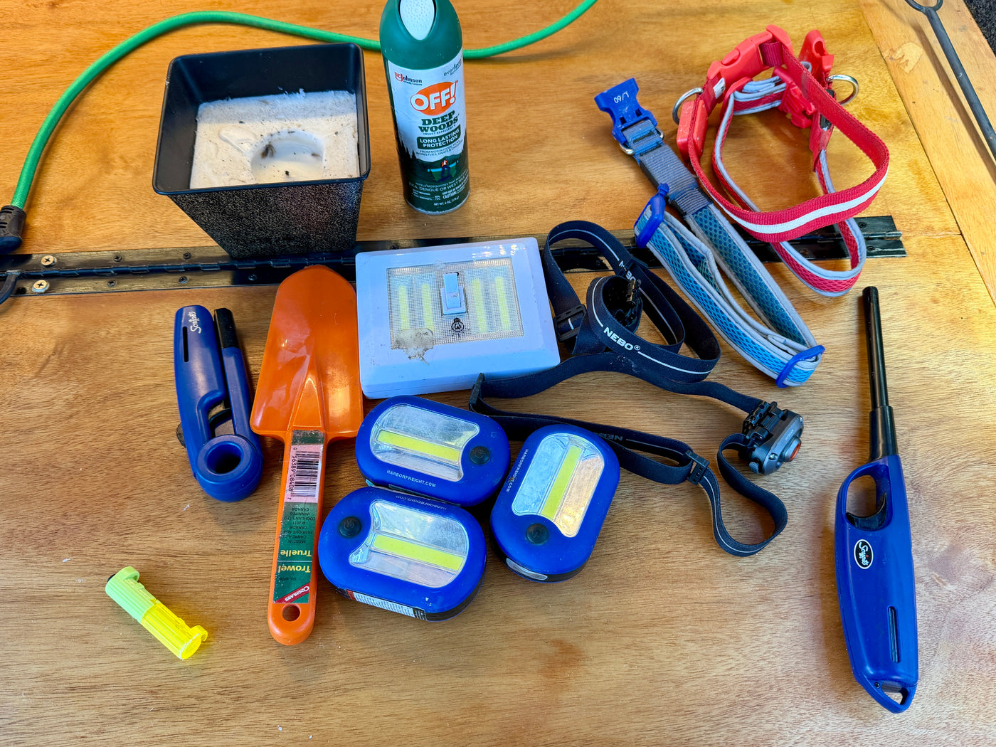 RV rental camping gear: portable lights, insect repellent, pet collars, trowel, and lighters for nature trips. — photo 20