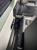 Luxury RV rental: detailed view of plush seating, integrated side control panel, and LOW AUTOMOTIVE display.