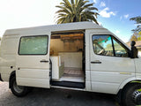 Explore this white Sprinter campervan rv rental, featuring a cozy kitchen & bench seating inside.