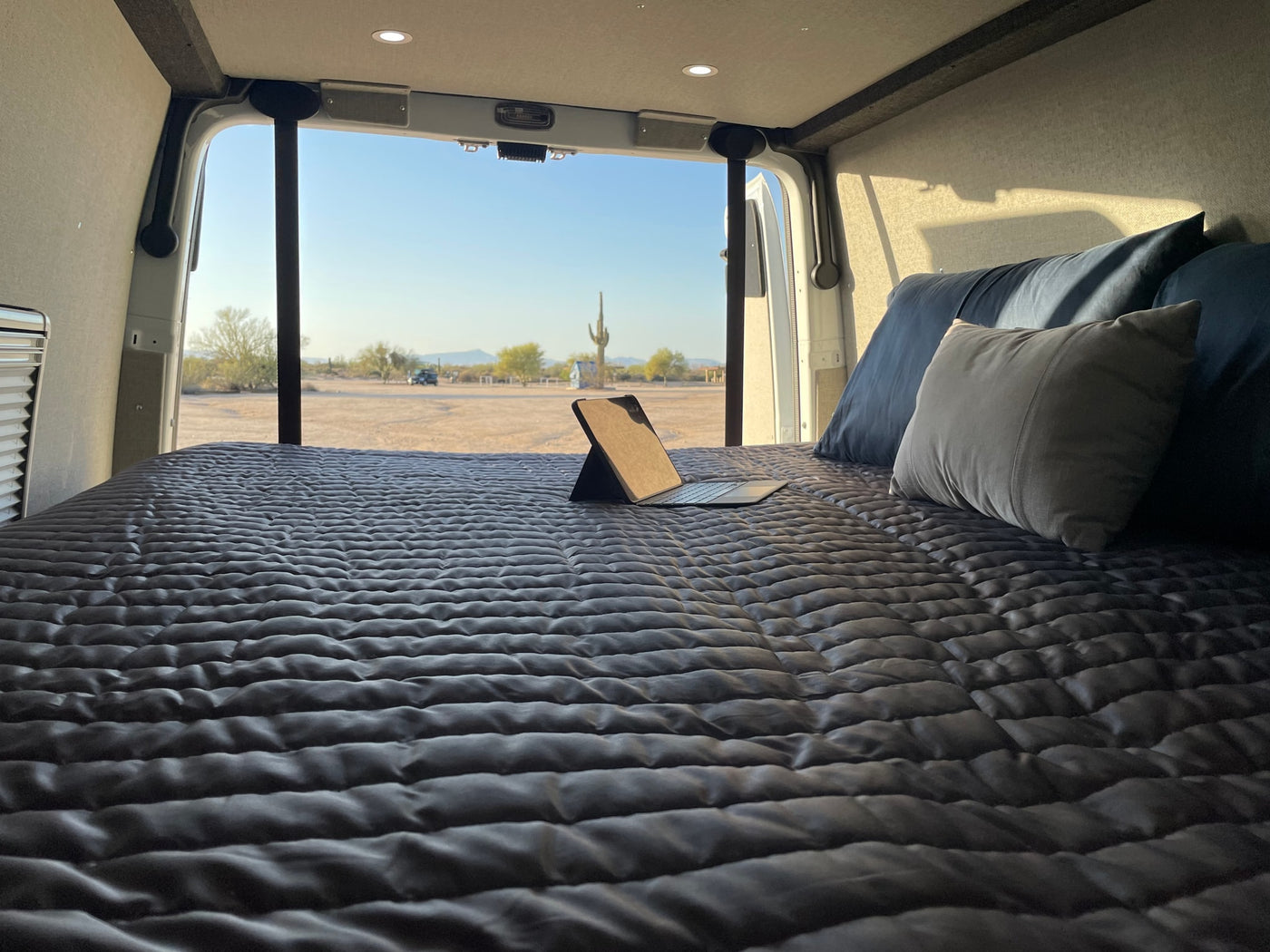  and overhead bed. Ready for road trips!|RV rental interior featuring a compact wet bath with toilet and shower — photo 6