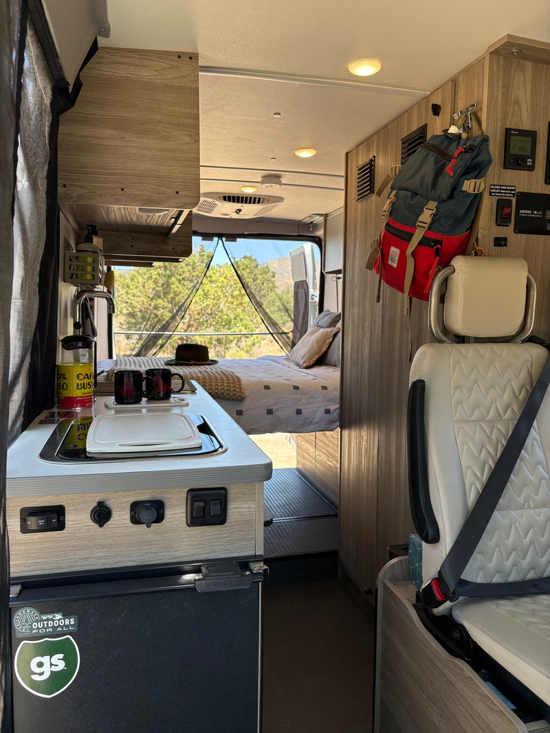  light breaks through clouds.|Perfect RV rental camping setup: open van doors — photo 17